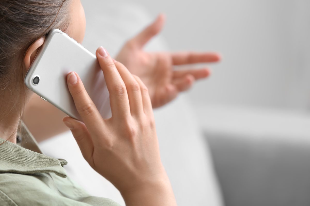 Woman Talking By Mobile Phone At Home
